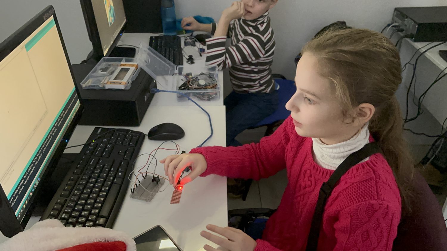 A student assembling an electronic circuit in class